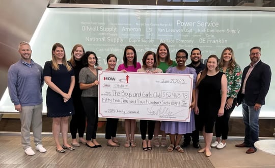This is an image of DNOW employees holding a giant check with the amount of money they donated to the Boys and Girls Club.