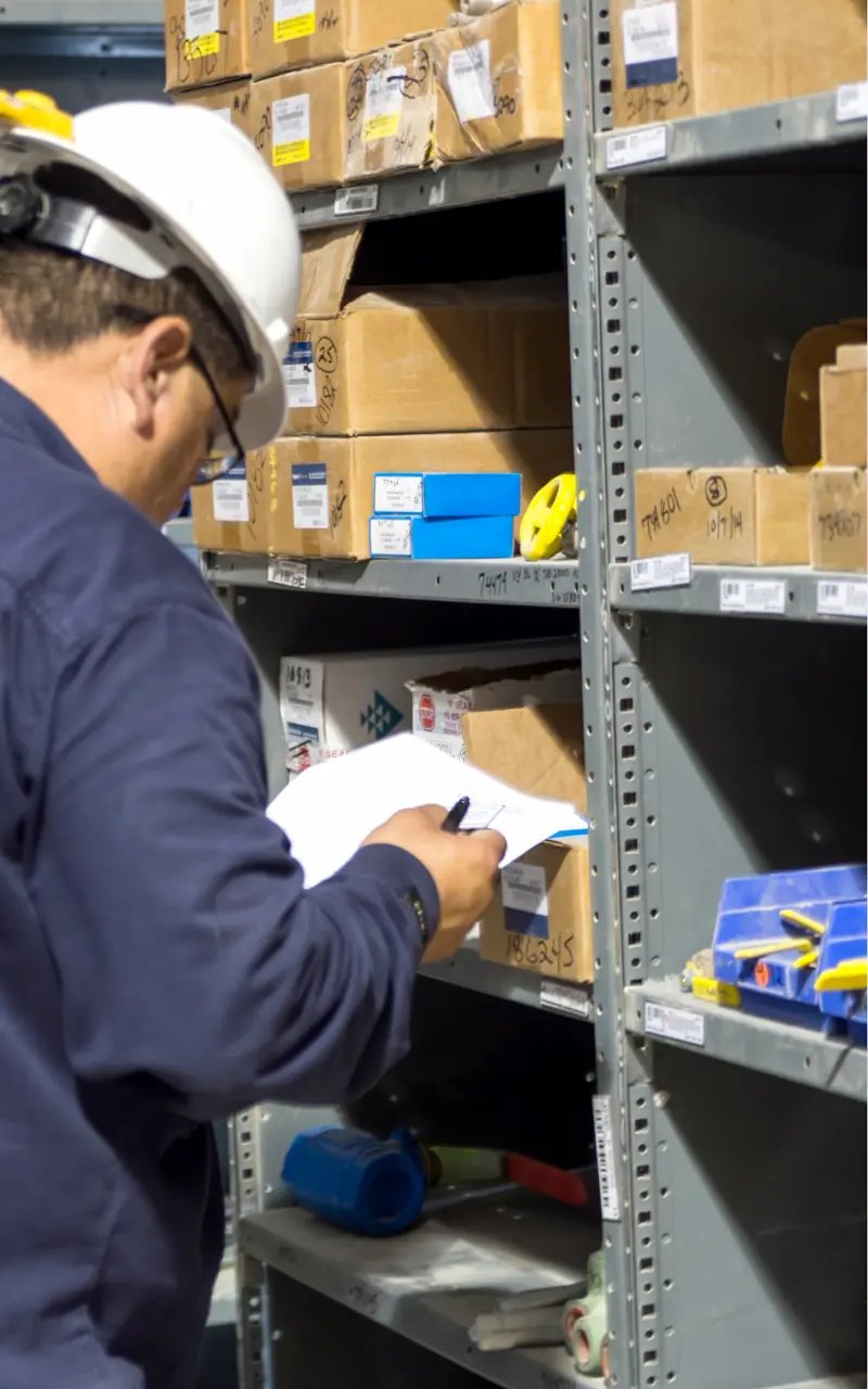 Image: DNOW employee selecting and preparing products from inventory shelves to fulfill a customer's specific order request.