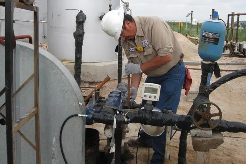 Photo of an Odessa Pumps technician performing a multiplex fluid end changeout on a pump in the field
